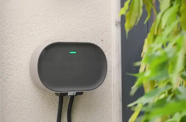 Home EV charger mounted on an outside wall